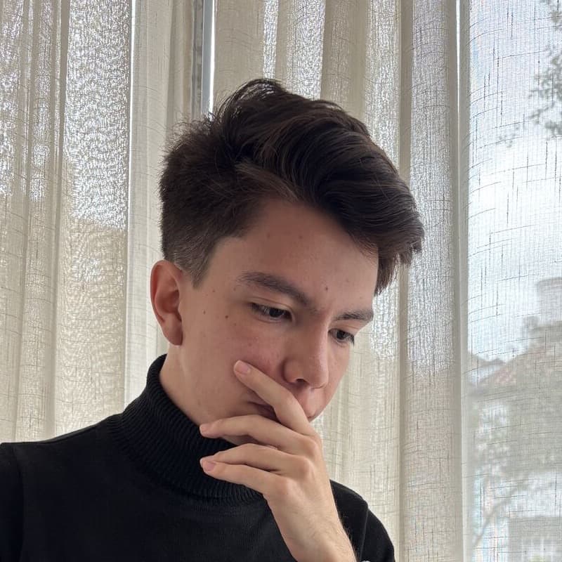 Lucas Leguizamo, Colombian software developer, in a black turtleneck by a window